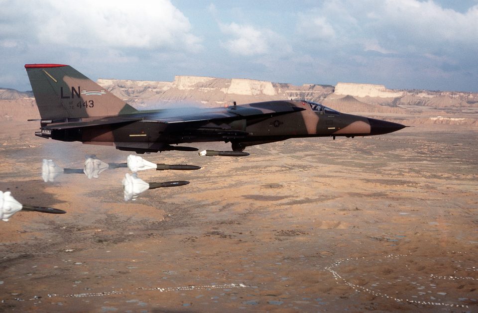 An air-to-air right side view of a 494th Tactical Fighter Squadron, 48th Tactical Fighter Wing F-111F aircraft releasing its load of Mark 82 high-drag bombs. 