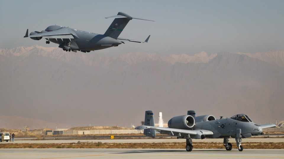 Afghanistan, AC-17 takes off while an A-10 rolls in for landing at Bagram Airfield 