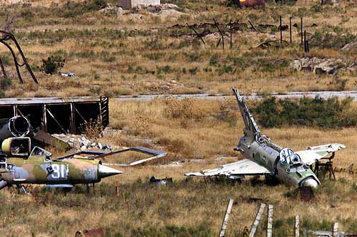 Destroyed Taliban MiGs lie on the Bagram air base frontline 2001.