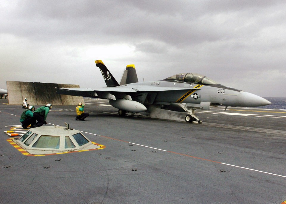 A US Navy F/A-18F Super Hornet aircraft assigned to the "Jolly Rogers" of Strike Fighter Squadron 103 (VFA-103), prepares to launch from the flight deck of the Nimitz-class Aircraft Carrier USS Dwight D. Eisenhower, 2006