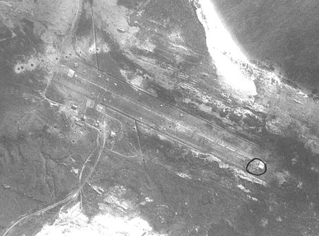 Aerial reconnaissance photo of Port Stanley Airport. The craters from Black Buck One's bombs are visible in the middle. Black Buck Two's craters are visible more clearly to the left.