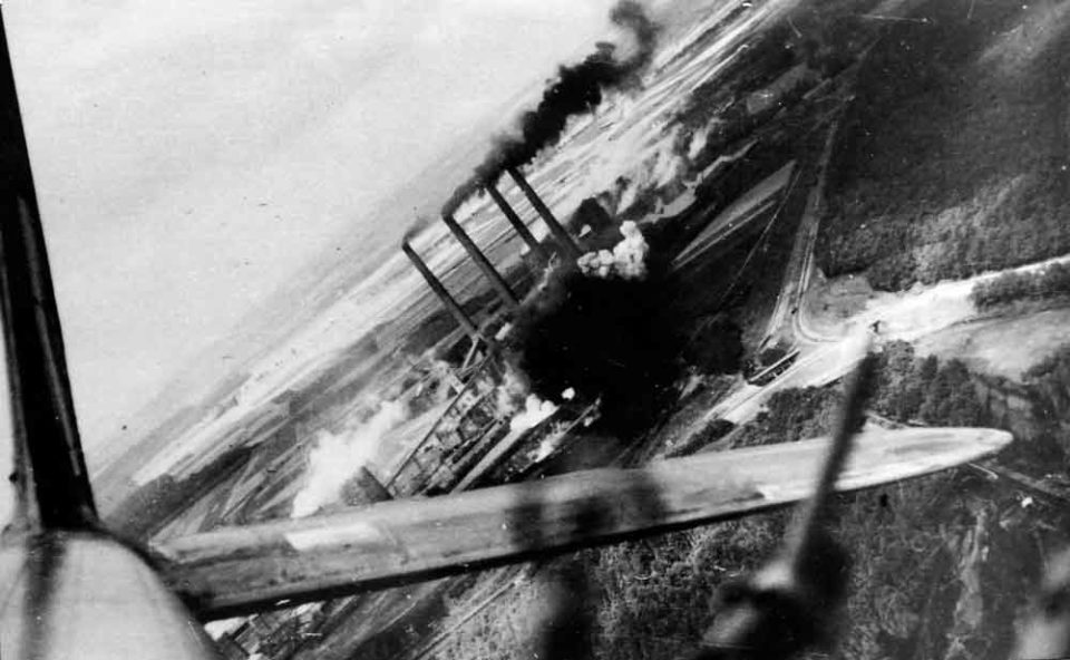 The view from a Blenheim bomber as it finishes its bomb run over the other Cologne power station with bombs exploding on target.