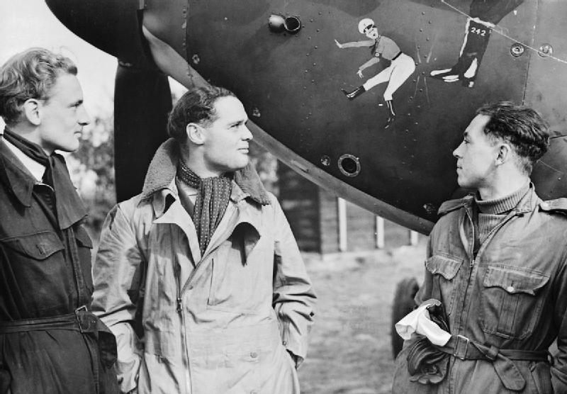 Squadron Leader Douglas Bader (centre) and fellow pilots of No 242 Squadron Flight Lieutenant Eric Ball and Pilot Officer Willie McKnight admire the nose art on Bader's Hawker Hurricane at Duxford October 1940 