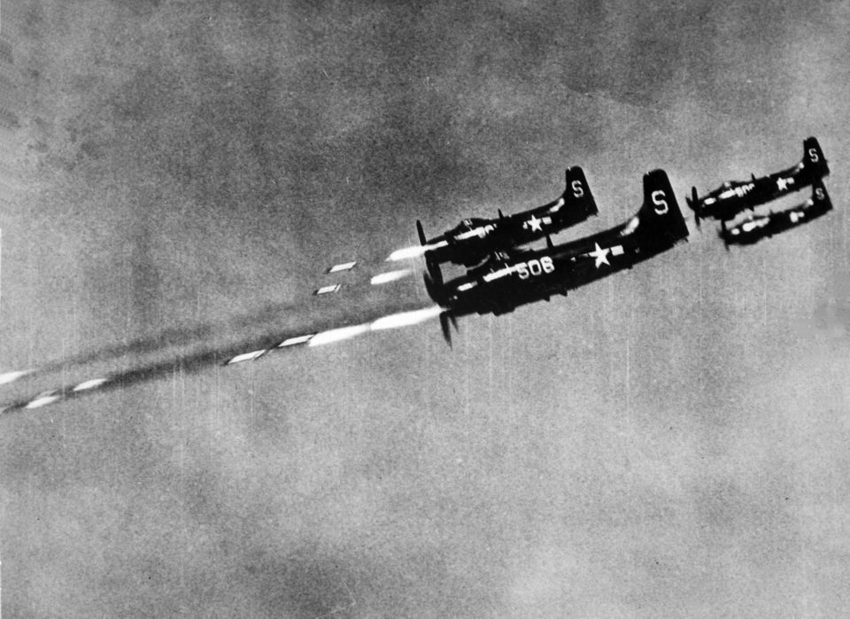 U.S. Navy Douglas AD-4 Skyraiders from Attack Squadron 55 (VA-55) "Torpcats" fire 5-inch HVAR rockets at a North Korean field position on 24 October 1950. VA-55 was assigned to Carrier Air Group 5 (CVG-5) aboard the aircraft carrier USS Valley Forge (CV-45) for a deployment to the Western Pacific and Korea from 1 May to 1 December 1950.