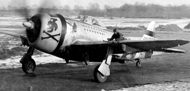 On a narrow pierced steel plank taxiway a ground crew situated on the wing helps taxi Maj. Glenn T. Eagleston back to his hardstand. The 353rd Thunderbolts carried all yellow cowling with black cowl flaps and winged skull and crossbones which would became one of the most memorable designs on a Thunderbolt.
