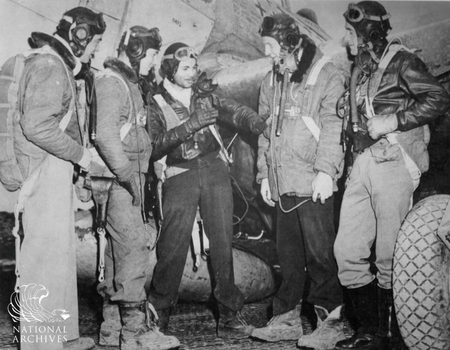 Glenn T. Eagleston (centre), leading 9th Air Force Ace, explains his maneuver to fellow pilots