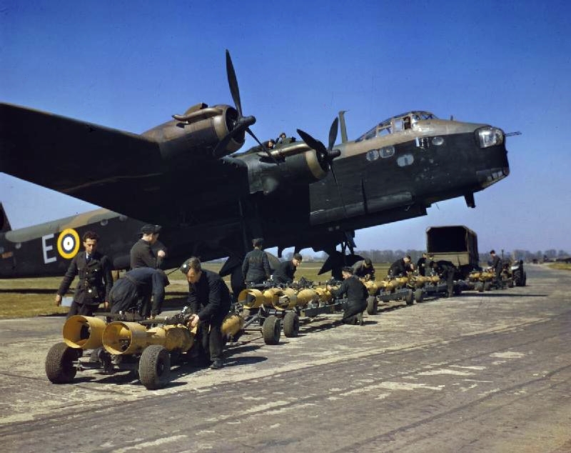 Royal Air Force armourers check over the sixteen 250lb bombs before they are loaded into a Short Stirling bomber (s/n N6101) of No. 1651 Heavy Conversion Unit at Waterbeach, Cambridgeshire. N6101 was one of the first Stirlings built by Short and Harland at Belfast.